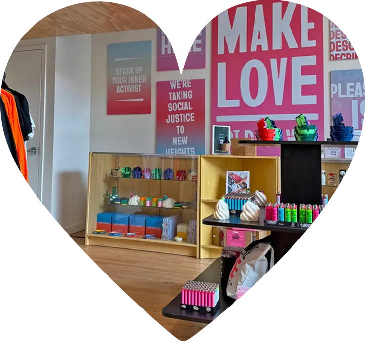 Interior of Housing Works Cannabis Co. dispensary featuring colorful products and activist-themed wall art.