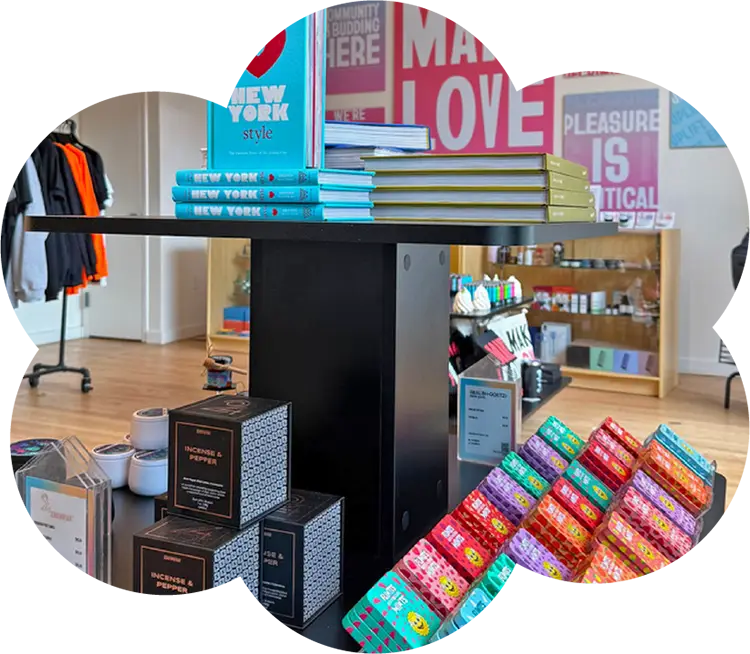 Retail display inside Housing Works Cannabis Co. featuring books, incense, and colorful cannabis product packaging.